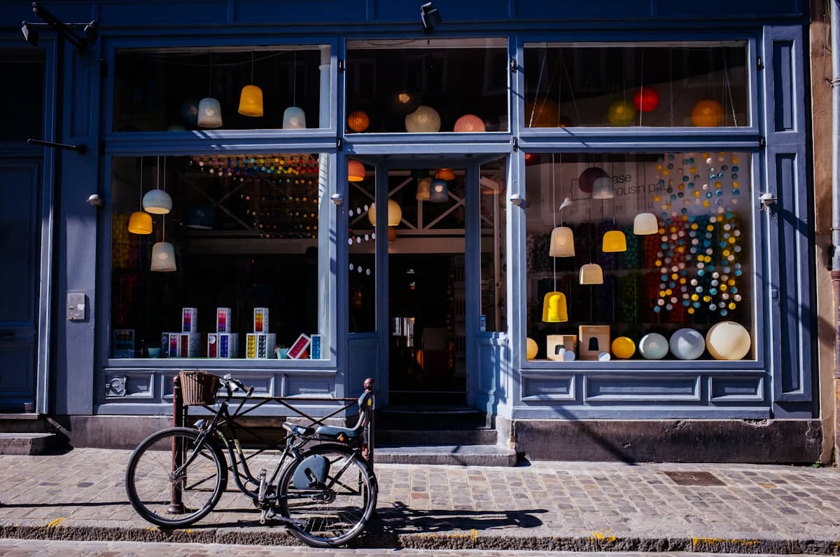 A colorful local shopfront on a quiet street with a bike parked out front, the kind of small business customers find on Google Maps.